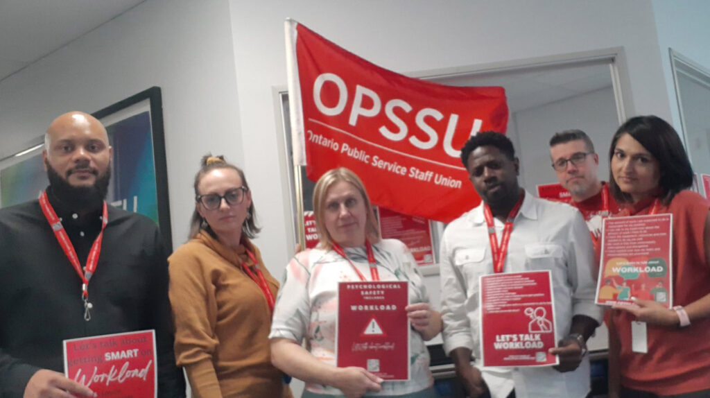 OPSSU members at the Ottawa regional office holding Let's Talk Workload posters.